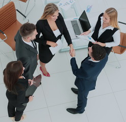 Successful busines team making handshake in an modern office