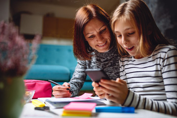 Mother and daughter using smart phone