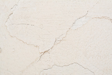 texture of the surface of an old antique wall with a plaster layer destroyed from moisture, a lot of cracks, blisters on the wall