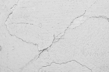 texture of the surface of an old antique wall with a plaster layer destroyed from moisture, a lot of cracks, blisters on the wall
