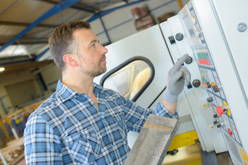 sawmill employee working with wood tools and machinery