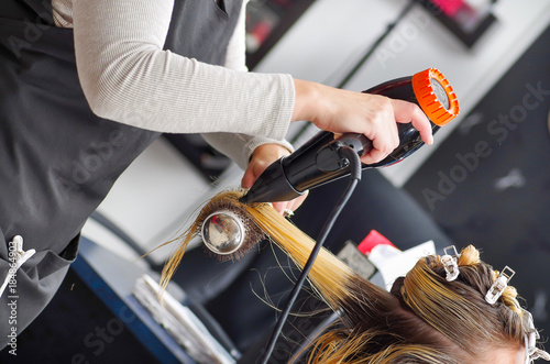 Close Up Of A Beautiful Woman In A Hair Salon And Hair Stylist