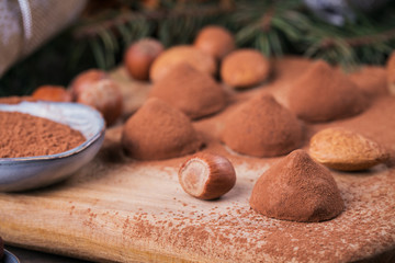 Homemade chocolate truffles, nuts, almonds and cocoa powder