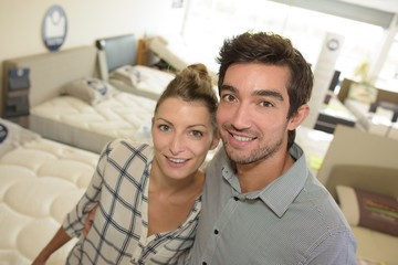 Portrait of couple in bed shop