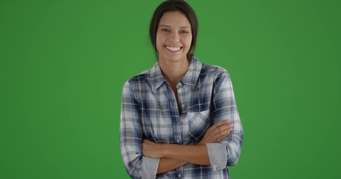 Young white girl standing happily wearing plaid on green screen. On green screen to be keyed or composited. 