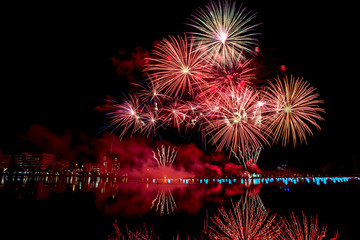 Beautiful fireworks on the water in the night sky