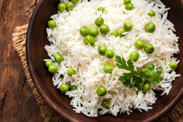 Basmati Rice Pilaf or pulav with Peas, or vegetable rice using green peas also known as matar pulav, served with plain dal
