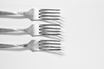 three forks, a canteen and a shadow - background