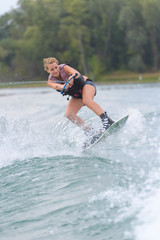 Fototapeta premium female wakeboarder making tricks on a lake