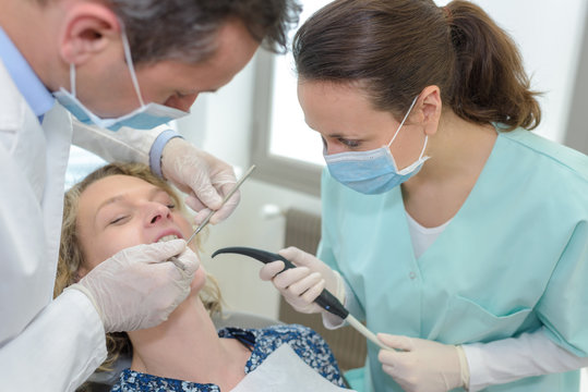 female patient with dentists