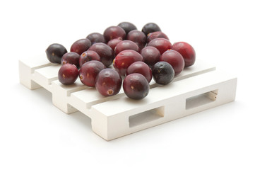 Cranberries on a pallet isolated on white background.
