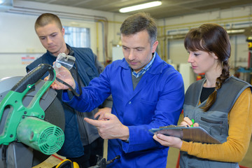 student in ironworks class using circular saw