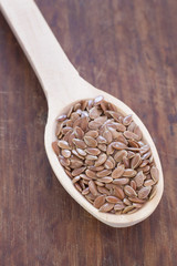 
Flax seeds. Wooden spoon on a wooden table. Rustic style.

