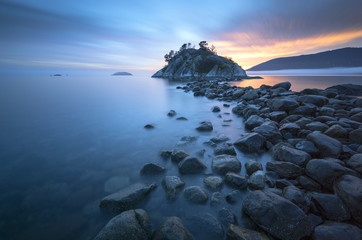 Naklejka premium Fog and mist roll into Whytecliff Park at sunset producing some vivid colors in West Vancouver BC Canada.