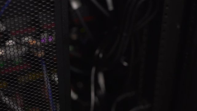 Male opening server doors, administrator checking network-attached storage