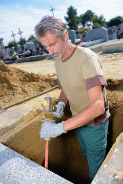man digging in a tomb