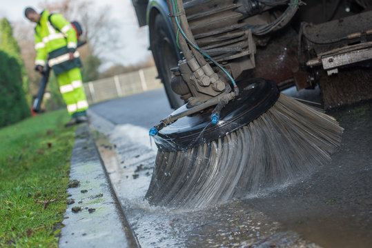 close up of a truck cleaning a street