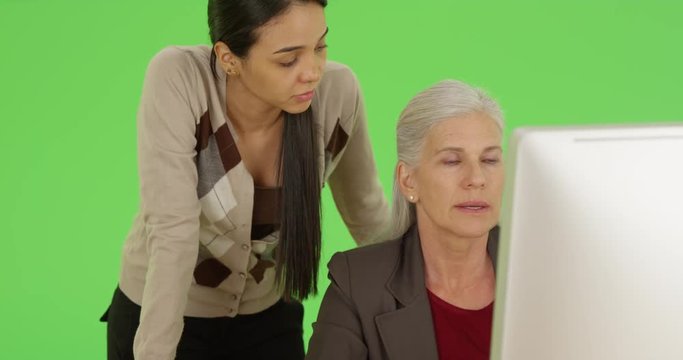 An office worker advises her boss on green screen. On green screen to be keyed or composited. 