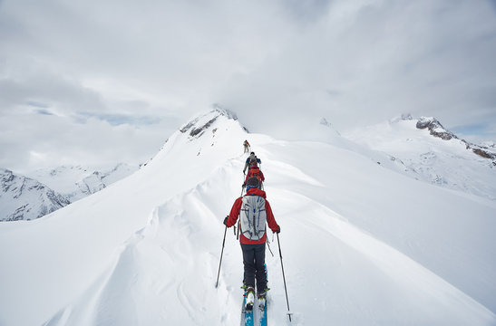 backcountry skiers on an alpine ridge