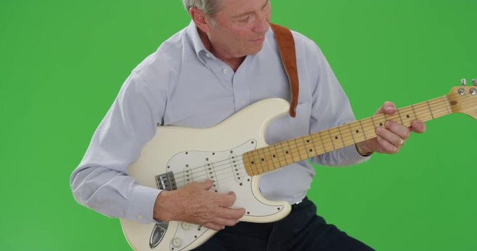 Front view of mid aged caucasian guitarist practicing guitar