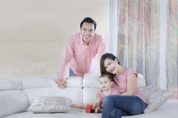 Parents playing with their daughter at home