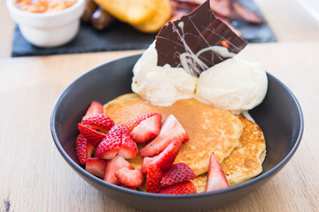 pancakes with strawberry and ice cream with chocolate garnishes