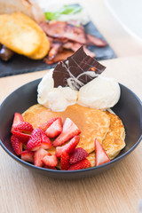 pancakes with strawberry and ice cream with chocolate garnishes