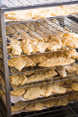 trays of breaded fish fillets ready for frying