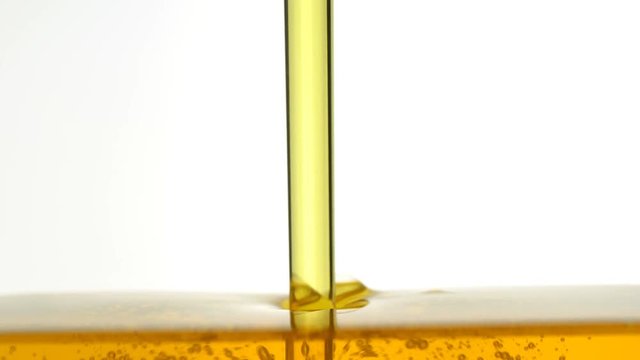 Motor oil pouring on white background. 
