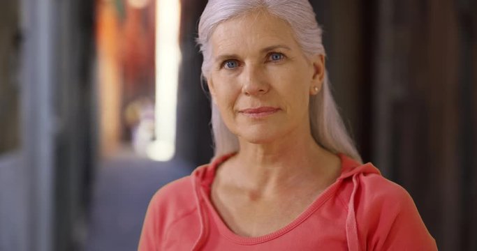 Casual portrait of cute happy mature woman smiling at camera