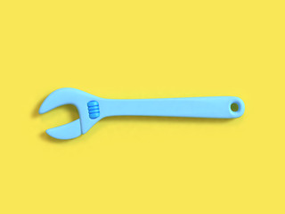 abstract wrench-spanner cartoon style 3d rendering yellow background technician industry concept