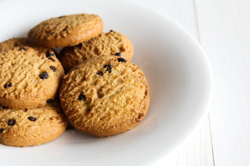 Chocolate chip cookies on wooden table.