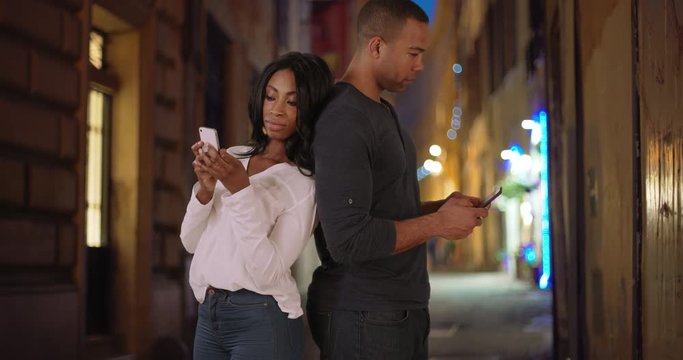 Young black woman shares something with boyfriend while browsing web in Italy