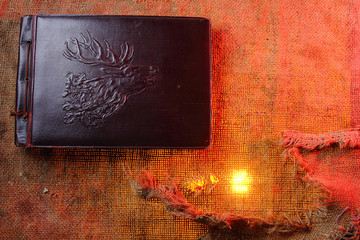 Old photo album. The texture of the fabric. Rough cloth Old cloth. Backgrounds for creativity.Torn fabric. The shade of red.