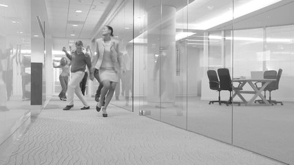 Businesspeople dancing down hallway