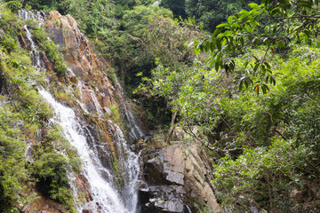 Fototapeta na wymiar Big waterfall in a tropical forest national park Ya Nuo Da in China on island of Hainan