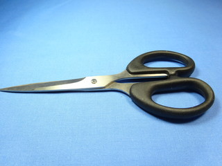 A black scissor on blue background