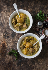 Beef potato massaman curry  on wooden background, top view. Comfort, delicious food in the asian style