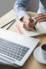 Closeup of Employee Making Notes in Office