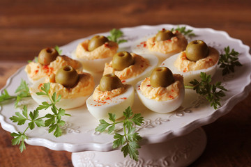 Spicy deviled eggs garnished with green olives