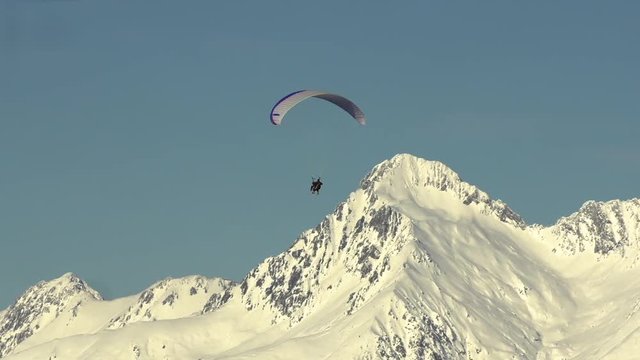 The Parachutist Plans In The Sky Near The Ridge
