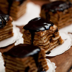 appetizing multi-layered cakes, poured with chocolate