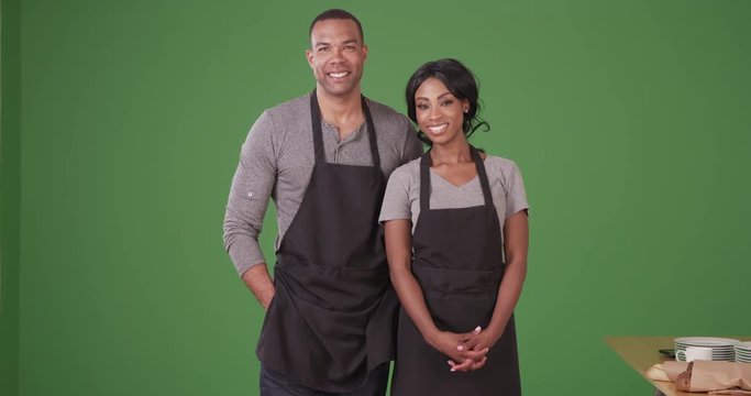 Portrait of African American man and woman small business owners on green screen. On green screen to be keyed or composited. 