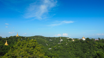 High angle view of multiple temples and pagodas on the mountains with Irrawaddy river in the background from sagaing hill, Sagaing region of Myanmar