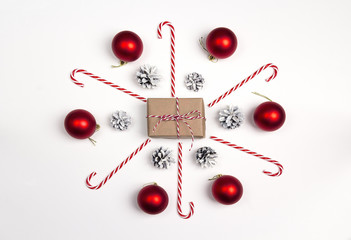 Christmas gift box with candy cane and decorating on white background. Holidays background.