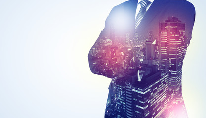Businessman standing with night city graphic
