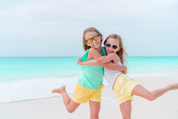 Adorable little girls during summer vacation. Kids enjoy their travel
