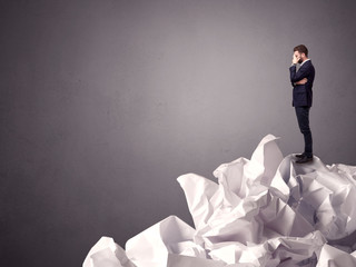 Businessman standing on crumpled paper