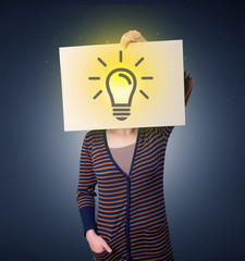 Woman holding paper with lightbulb