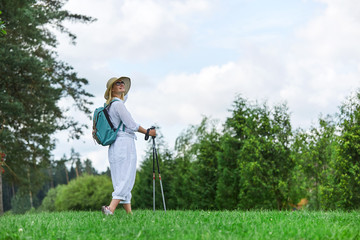 young woman with nordic walk pols